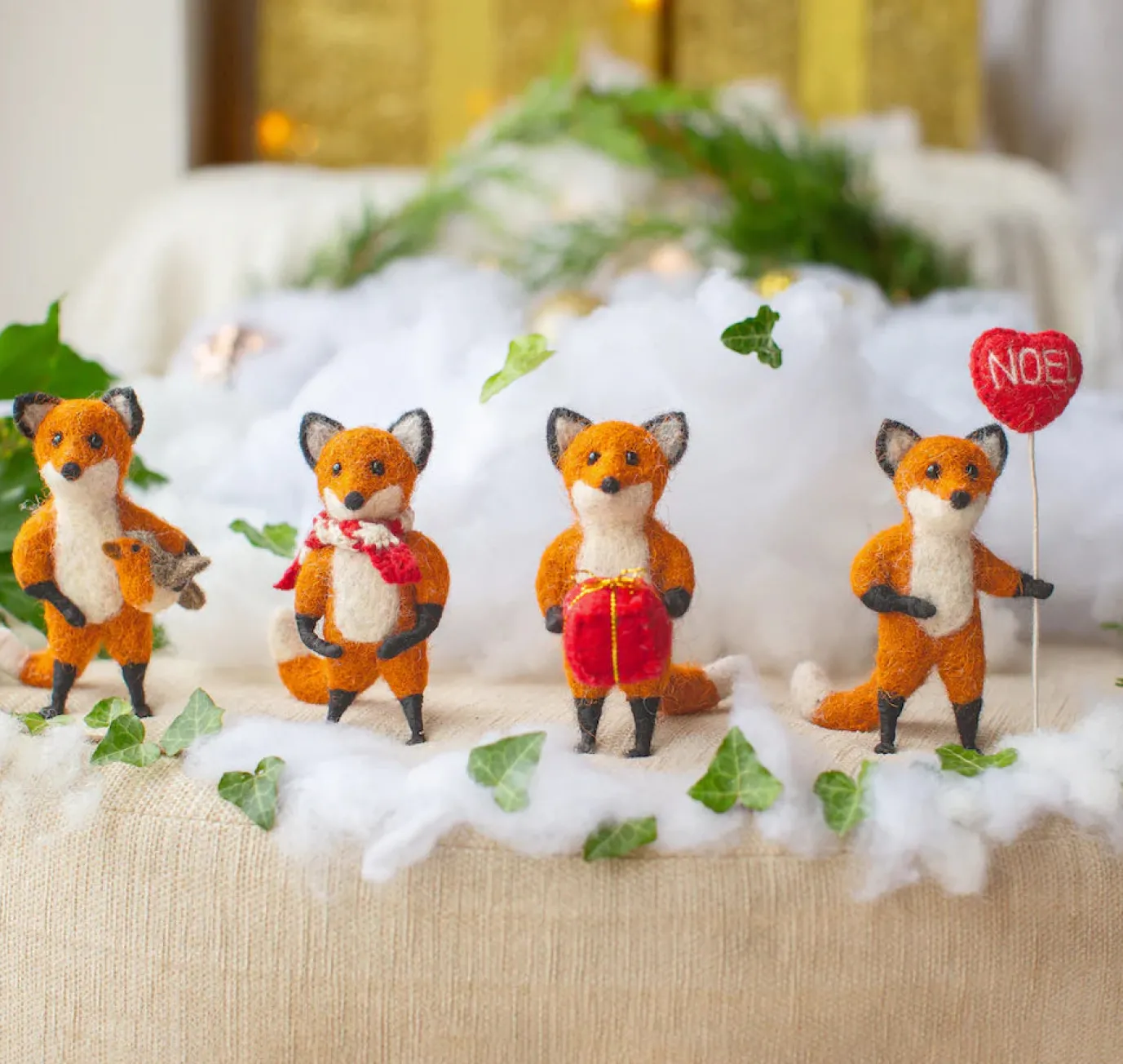 Hunter Fox Holding Holding a Robin Felt Decoration
